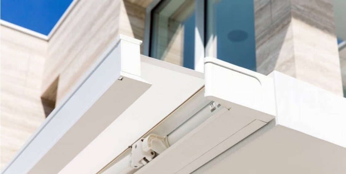 Modern Terasse mit Markise, Glaswänden und einem kleinen Wasserbecken.